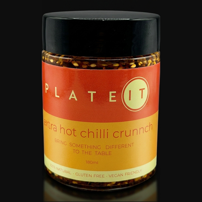 Plateit Extra Hot Chilli Crunch jar on a black background
