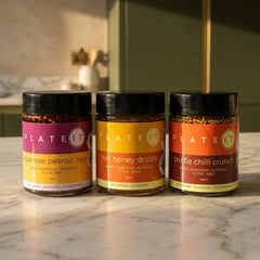 The Regulars bundle: Japanese Peanut Rayu, Hot Honey Drizzle and Truffle Chilli Crunch on a marble worktop