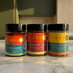 The World Tour bundle: Italian Chilli Oil, Bombay Chilli Crunch and Mexican Chilli Crunch on a marble worktop