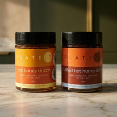 The Honey Two-Pack: Hot Honey Drizzle and Truffled Hot Honey Drizzle on a marble worktop
